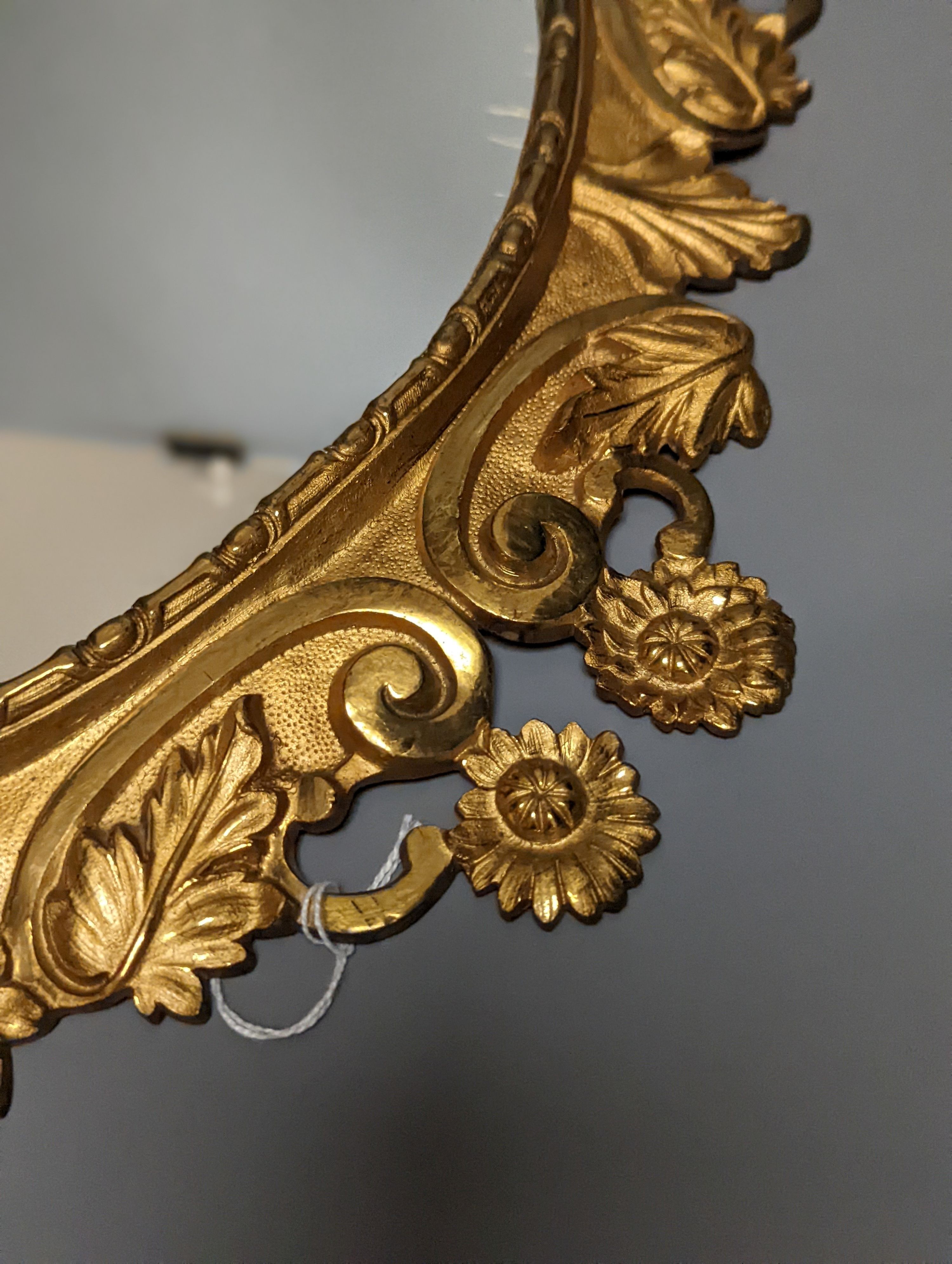 A pair of gilt brass wall mirrors, decorated with bats and flowers 56cm